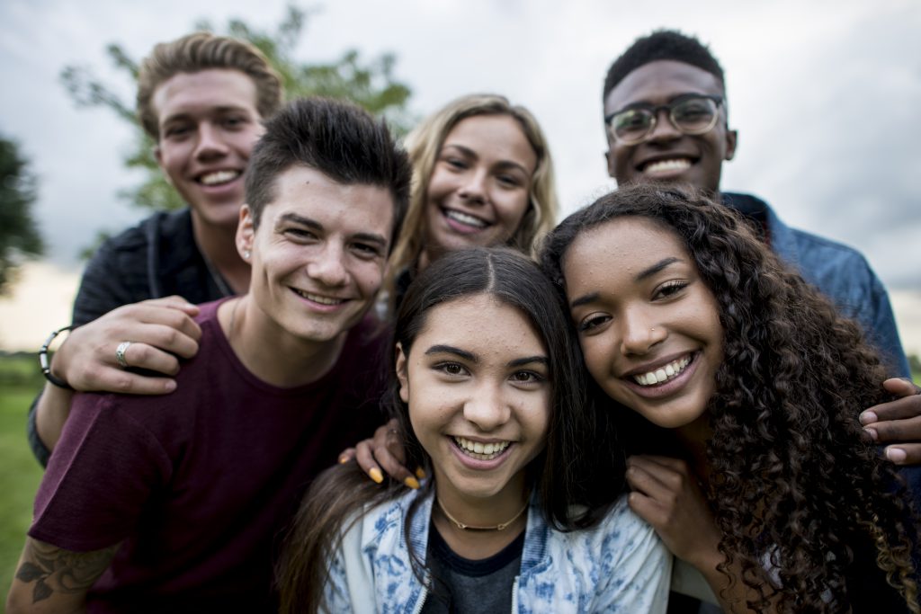 Group of diverse teens posting for a picture