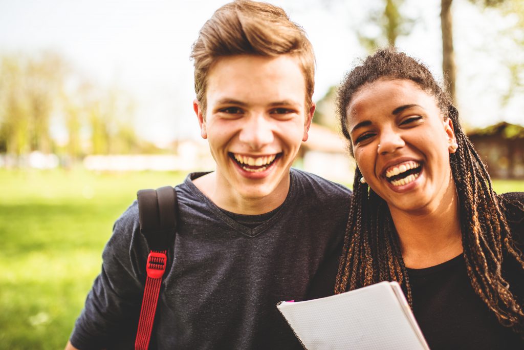 White teen male and African American Teen female smile