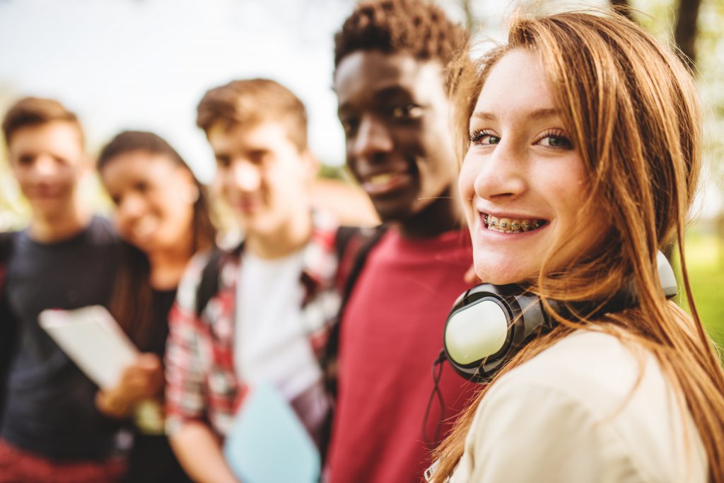 Diverse teens posting for a photo